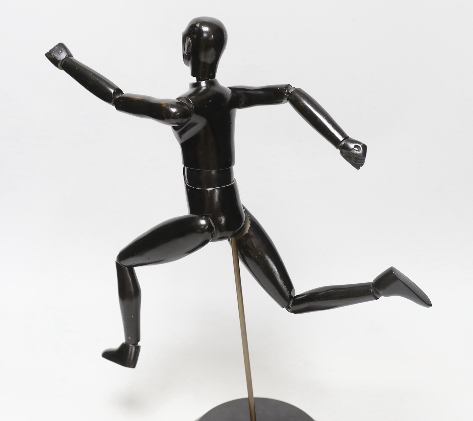 A carved wood lay figure on stand, 38cm